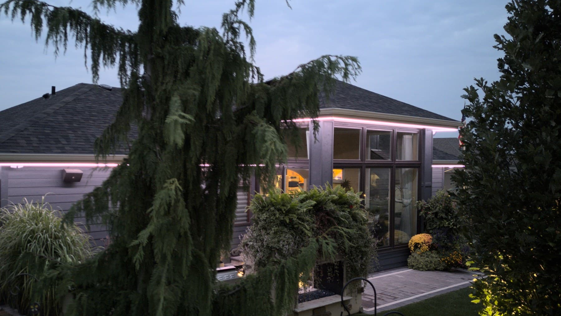 An Omaha home at twilight with its lighting just switched on
