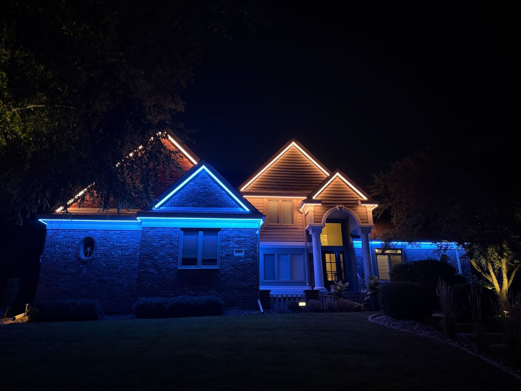 A brick Omaha home with the gable run in amber and the lower run in cyan