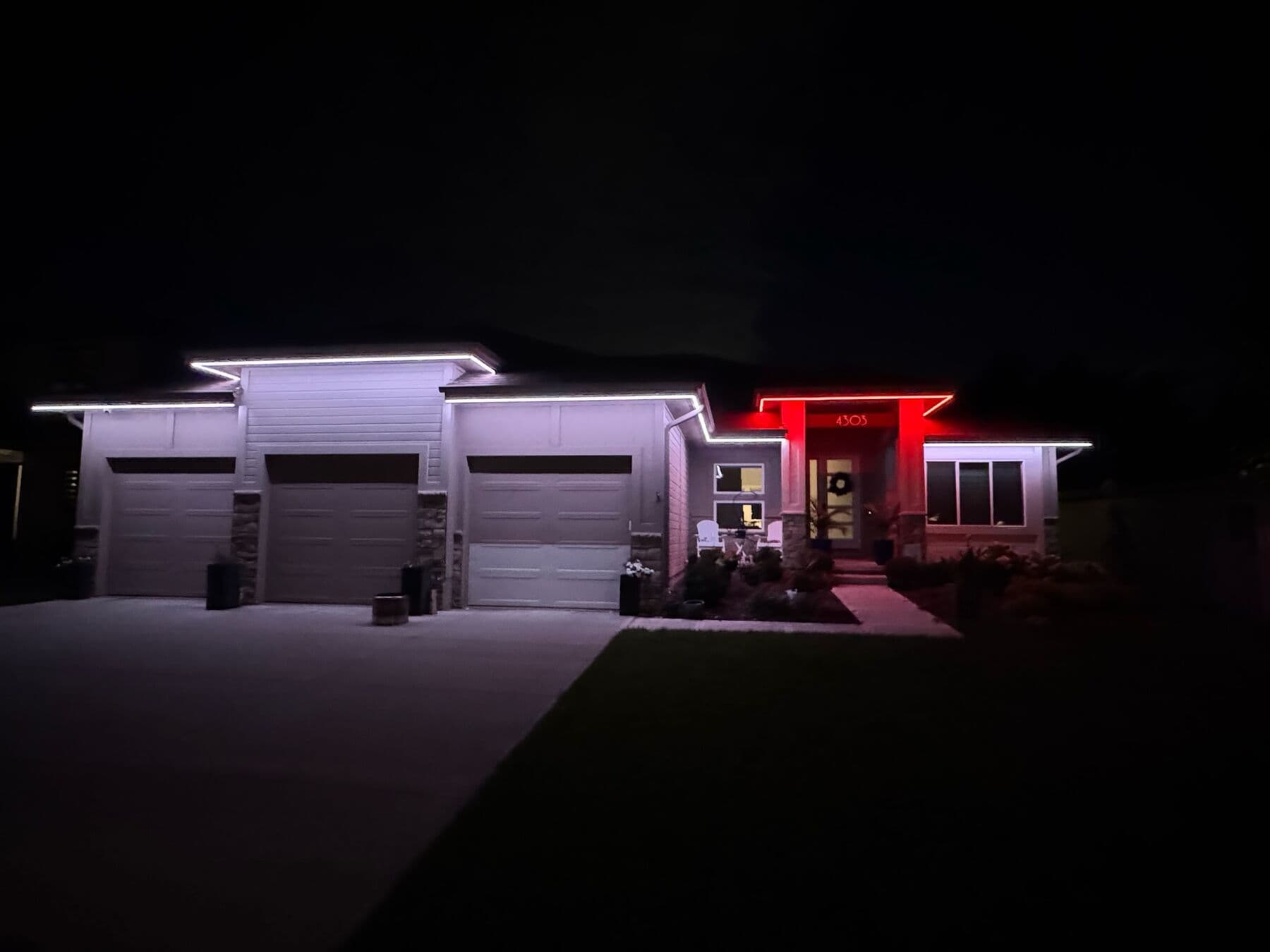 A wide Omaha ranch in cool white with only the entry alcove washed red