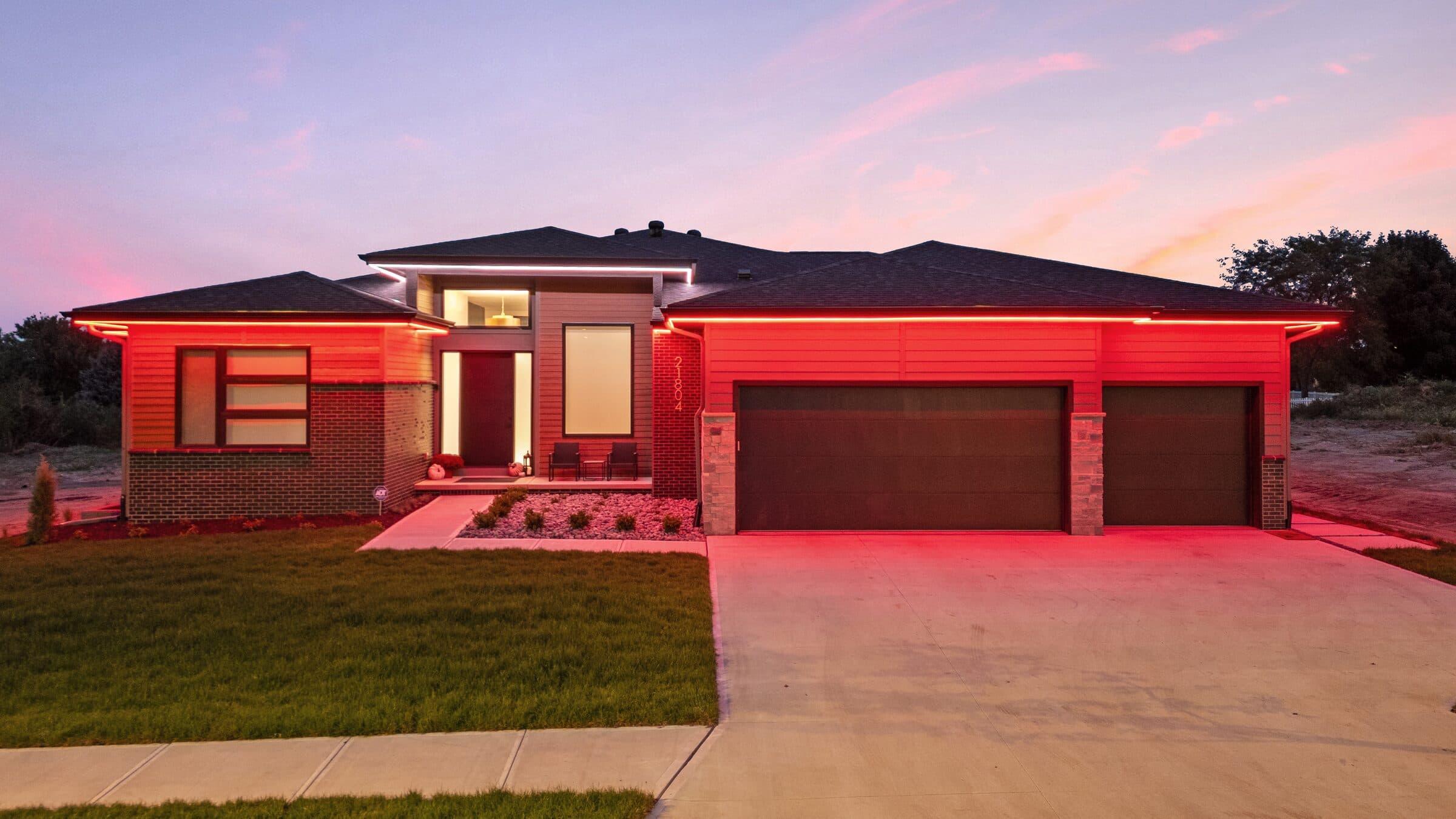 The same house washed red across the whole elevation with white left at the roof peaks