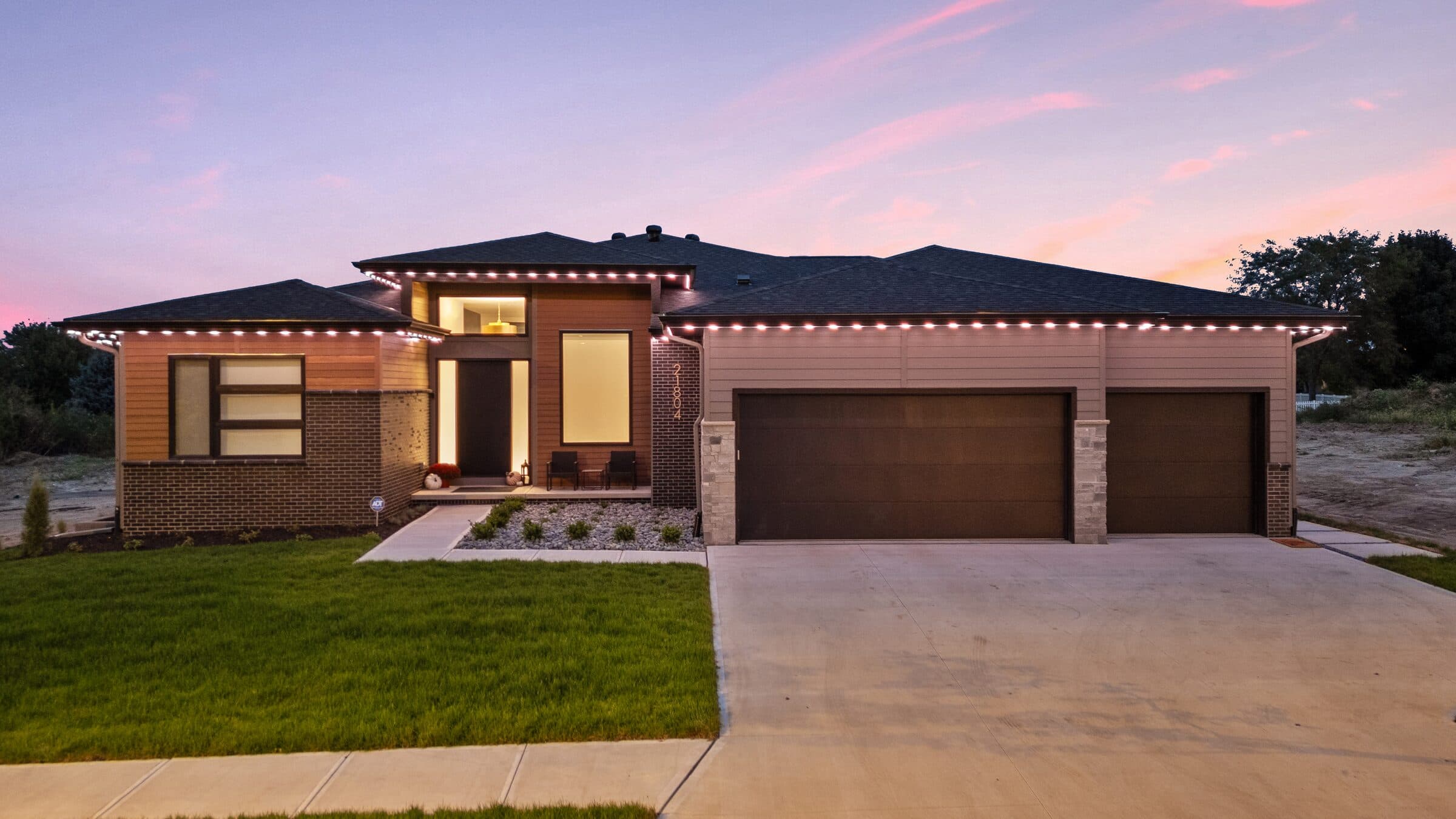The same house with every point along the roofline and eaves at full warm white